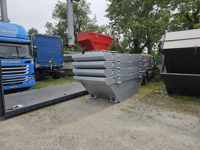 Graue, offene 4 m³-Absetzmulden, stapelbar, auf dem Betriebshof zwischen Lastwagen